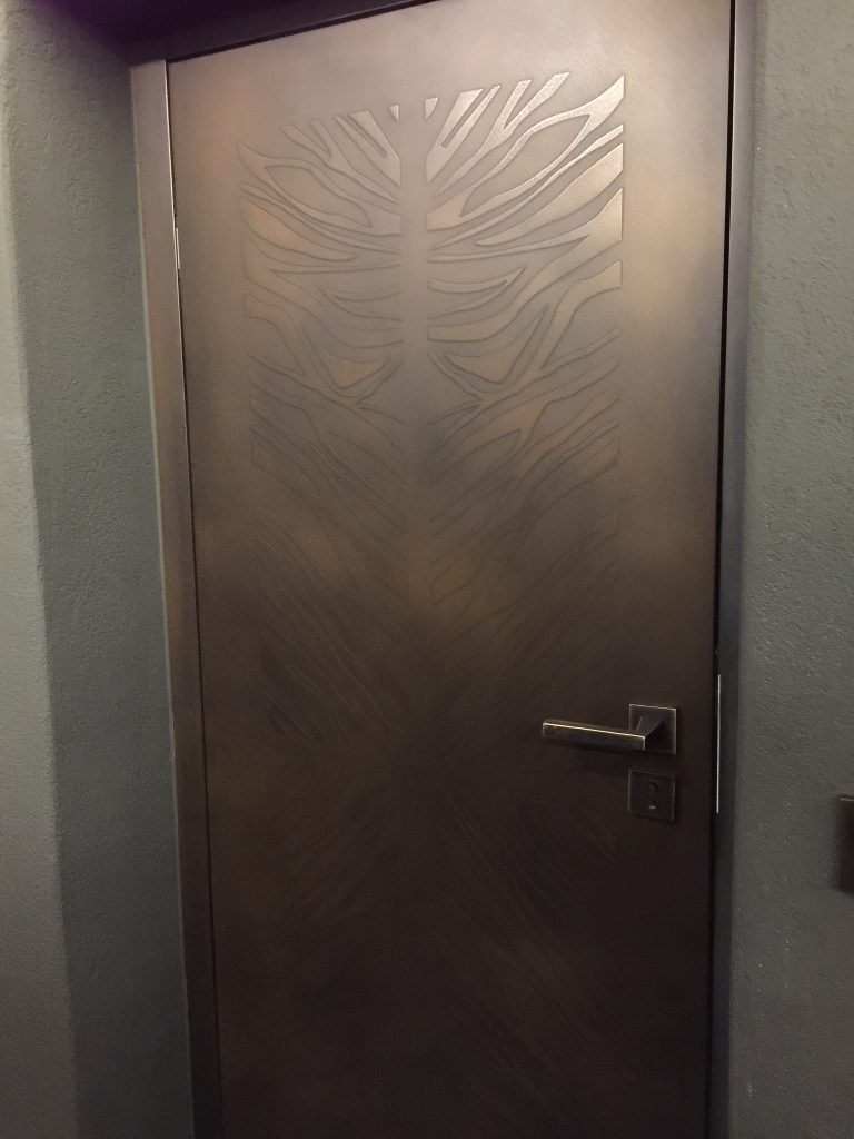 Decorative panel with subtle metal finish